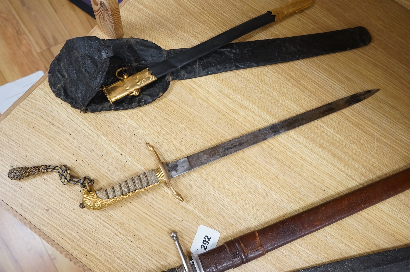 A post 1902 regulation Naval Officer’s dirk with lion’s head pommel, bullion dress knot, shark skin covered grip, in its leather scabbard, the gilt locket engraved with owners initials; CHCO’ R, the blade etched with cro